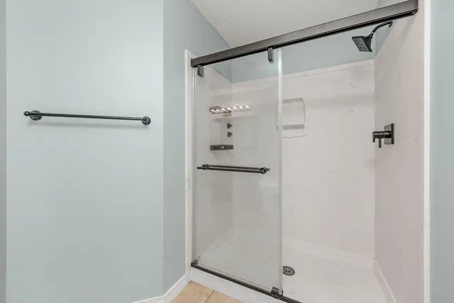 a bathroom with a glass shower door