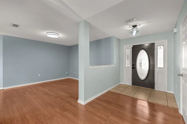 a view of a room with wooden floor and workspace