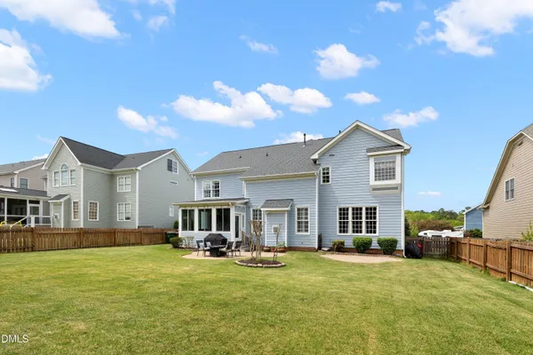 a view of a house with backyard porch and sitting area