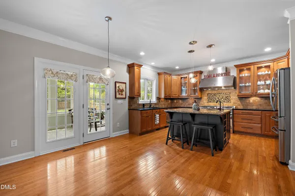 a kitchen with wooden cabinets and a stove top oven