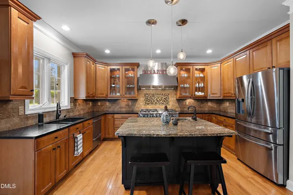 a view of a kitchen with wooden floor and electronic appliances