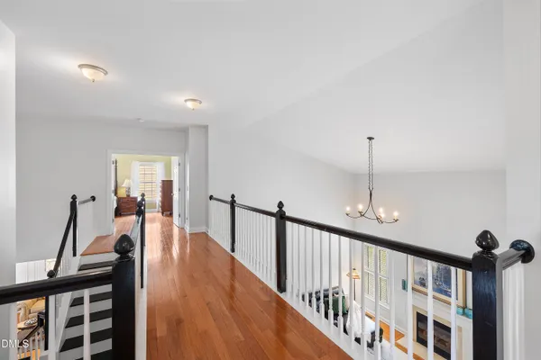 a bedroom with a bed and dresser with mirror