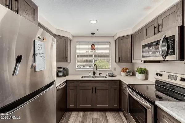 a kitchen with a sink stove and microwave