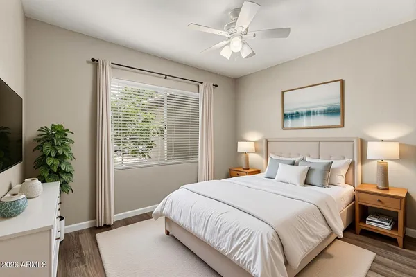 a bedroom with a large bed and a window