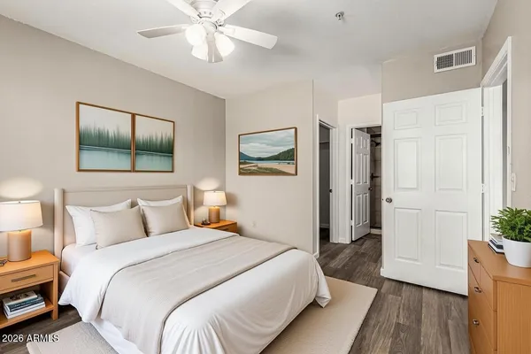 a bedroom with a bed and a chandelier