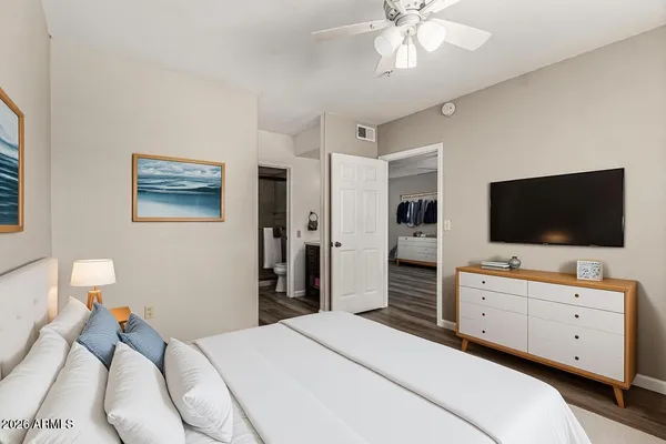 a bedroom with a bed and a flat screen tv