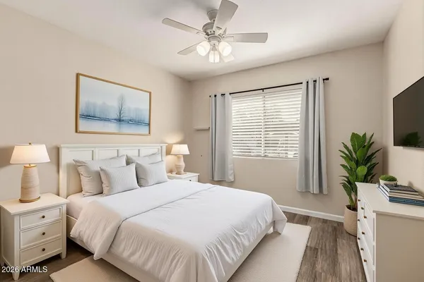a bedroom with a bed and a potted plant