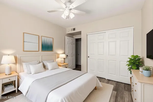 a bedroom with a bed and a chandelier