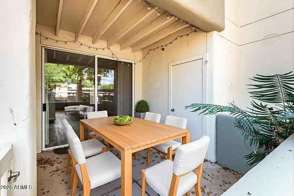 a view of an outdoor dining space with a table and chairs