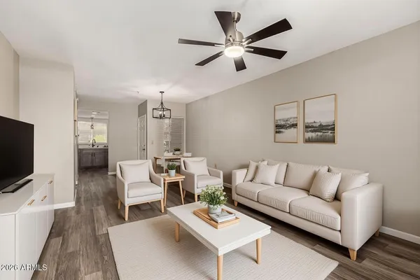 a living room with furniture a rug and a flat screen tv