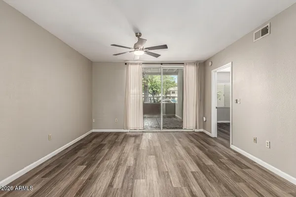 wooden floor in an empty room with a window