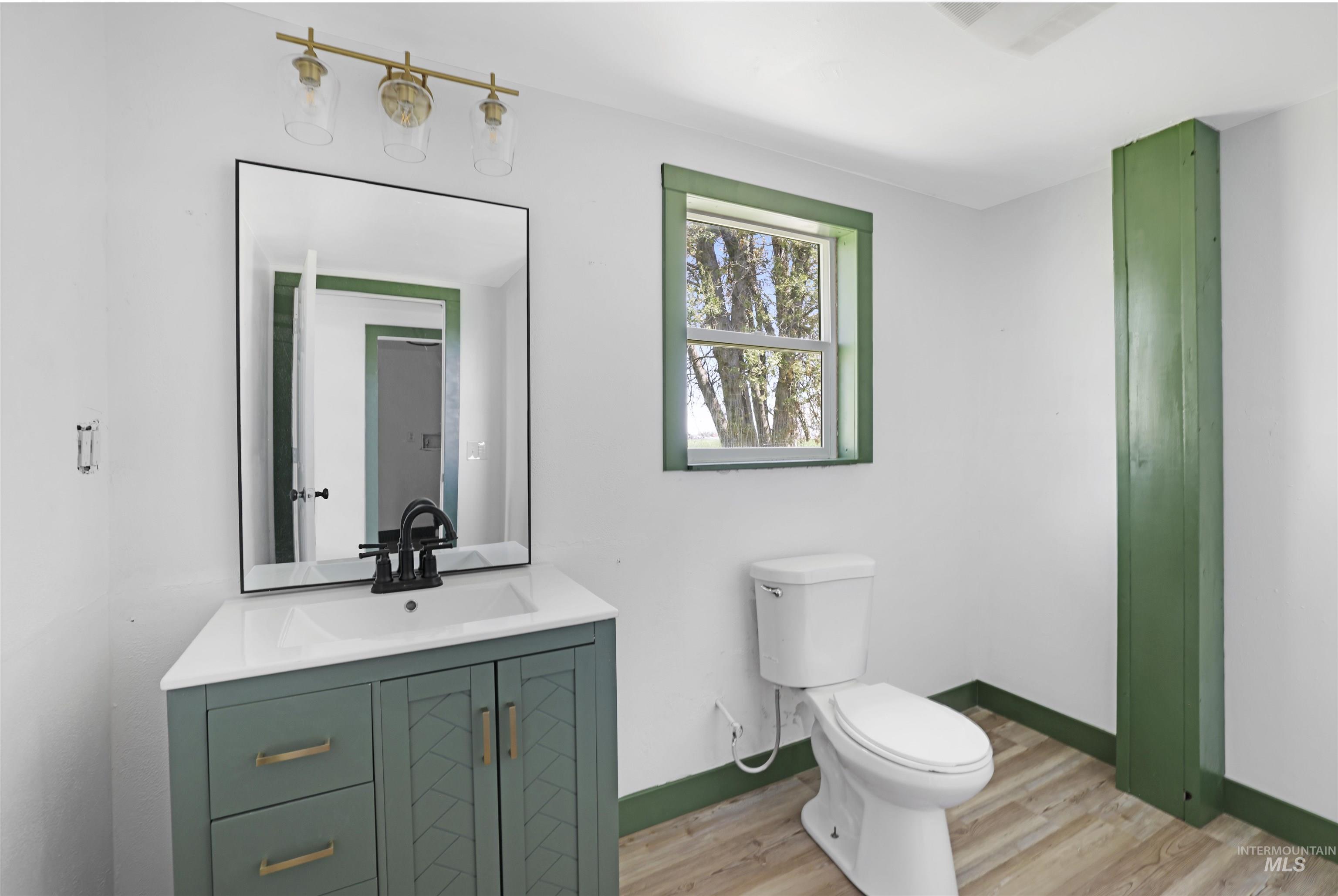 102 South 400 West Rupert, ID 83350 - Photo 14 of 15 Bathroom featuring vanity and wood finished floors