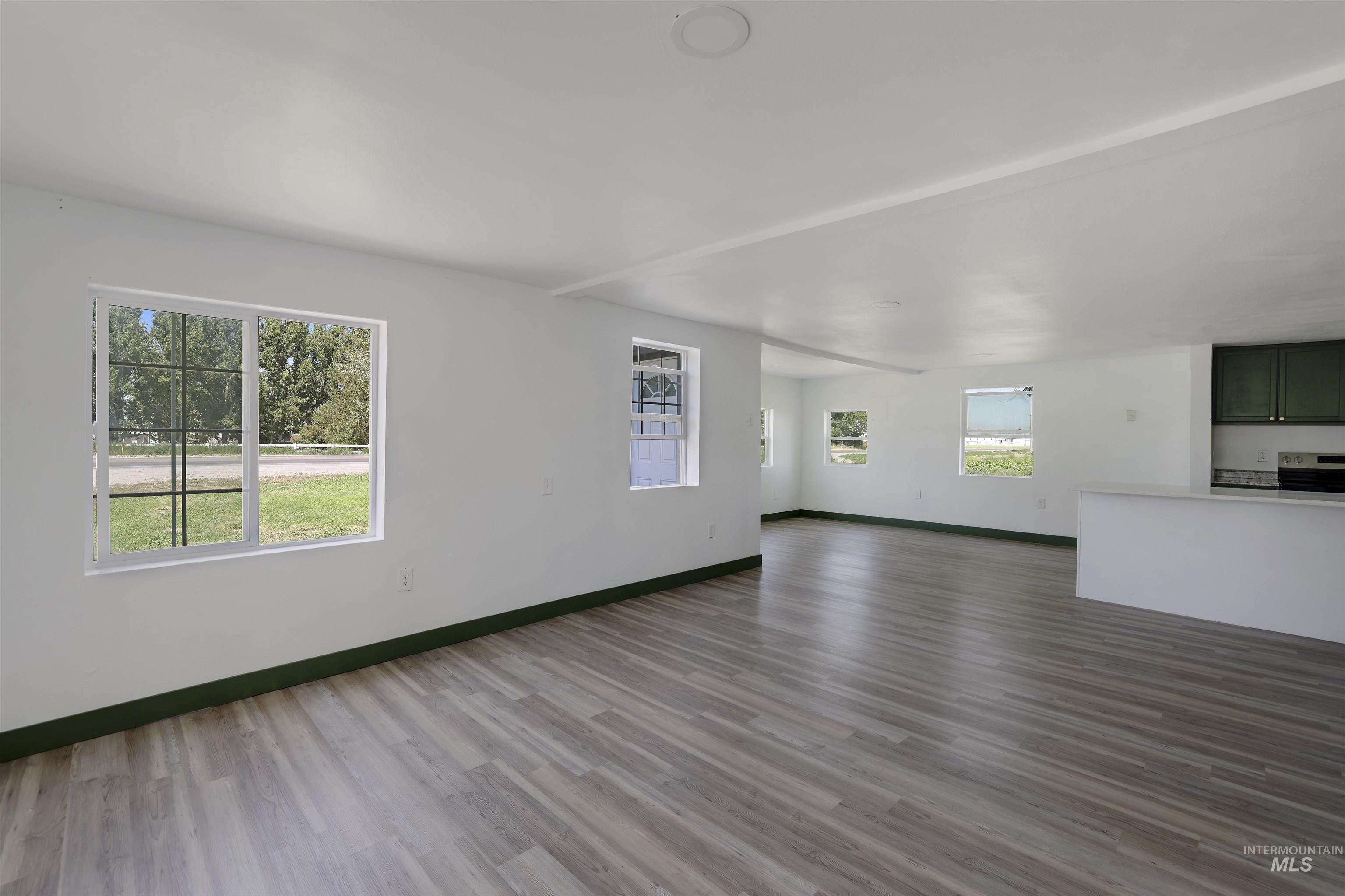 102 South 400 West Rupert, ID 83350 - Photo 3 of 15 Unfurnished living room with wood finished floors