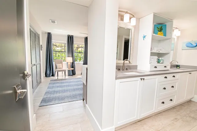 a en suite bathroom with a double vanity sink and a mirror
