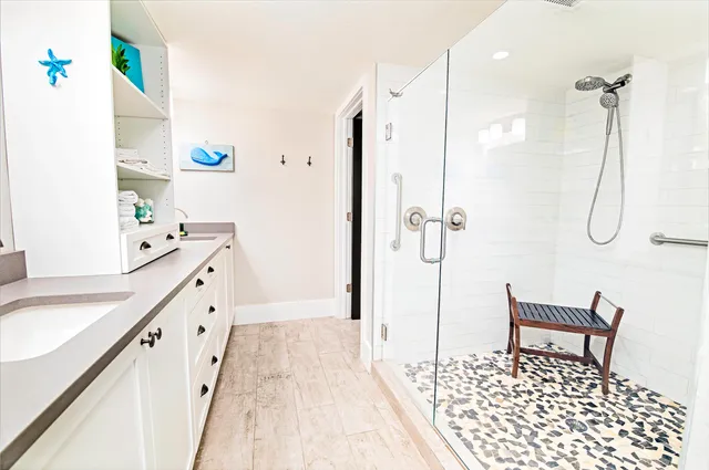 a bathroom with a bathtub a sink and a shower