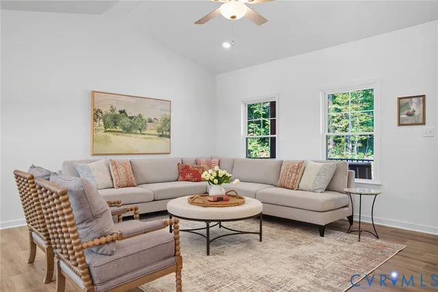 a living room with furniture a rug and a mirror
