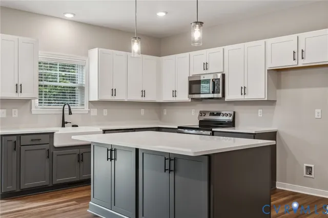 a kitchen with stainless steel appliances granite countertop a sink stove and cabinets