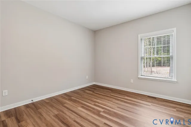 a large kitchen with stainless steel appliances granite countertop a large counter top a sink and a wooden floors