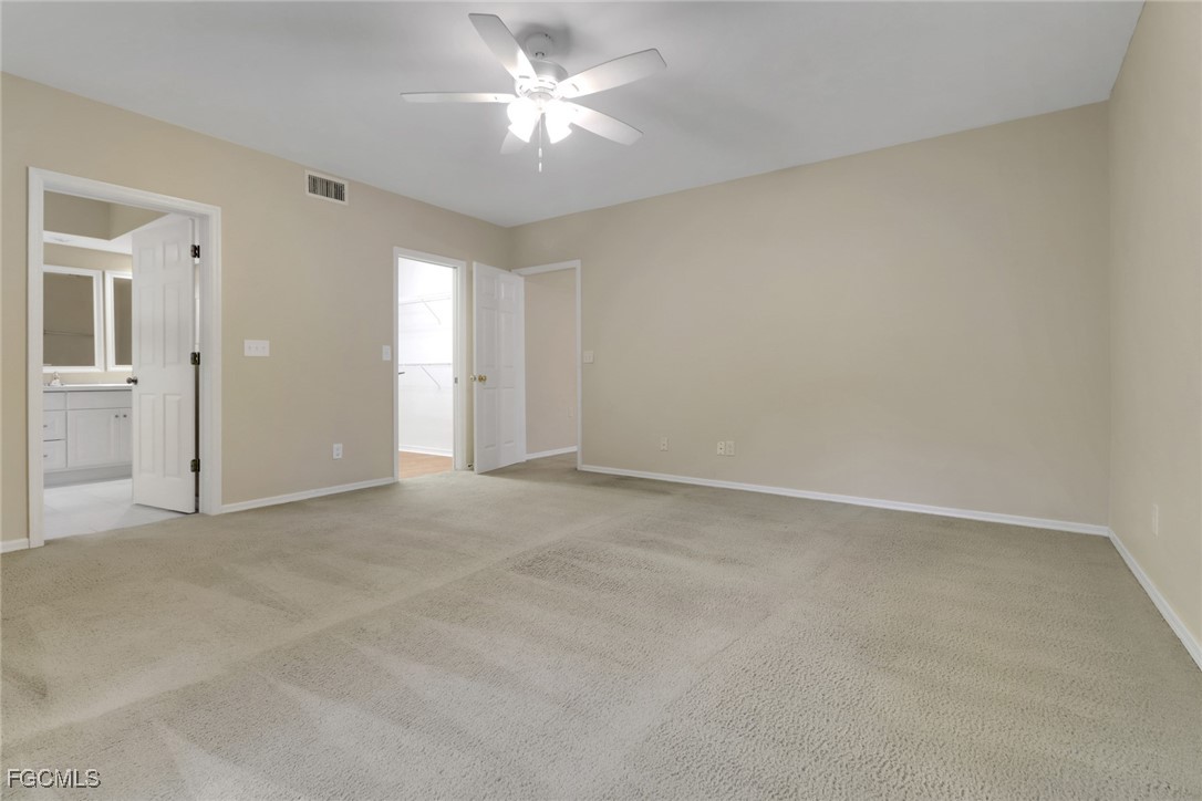 100 Siena Way, Unit 1201 Naples, FL 34119 - Photo 12 of 25 an empty room with a ceiling fan and a window