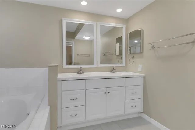 a bathroom with a double vanity sink mirror and double