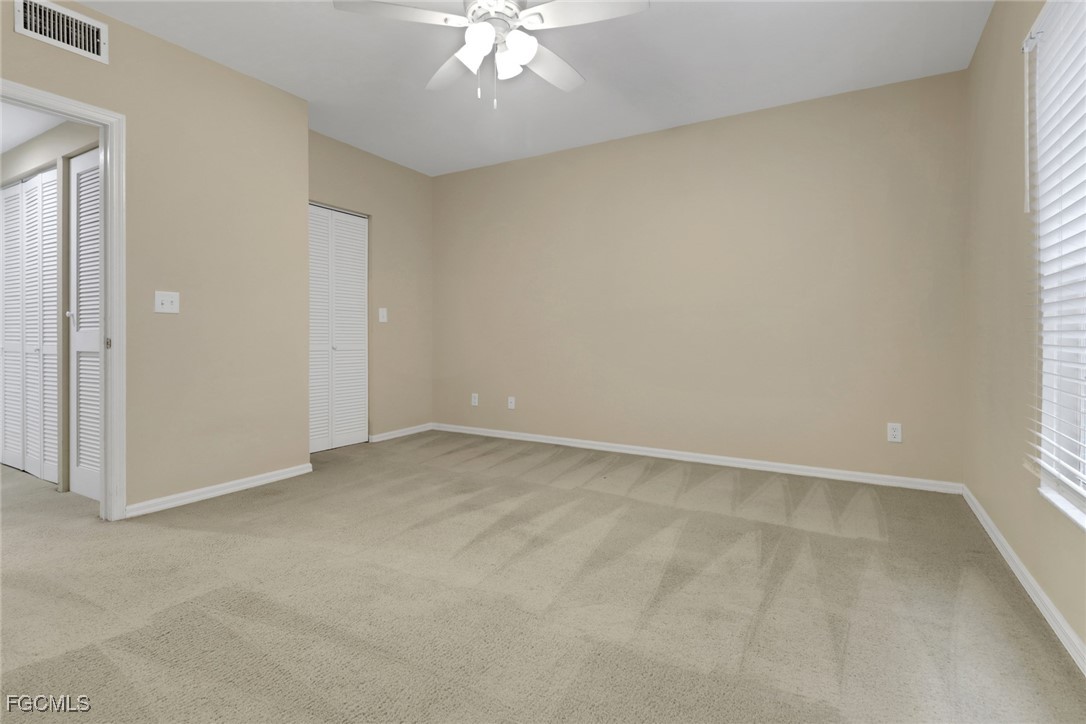 100 Siena Way, Unit 1201 Naples, FL 34119 - Photo 17 of 25 an empty room with a chandelier fan