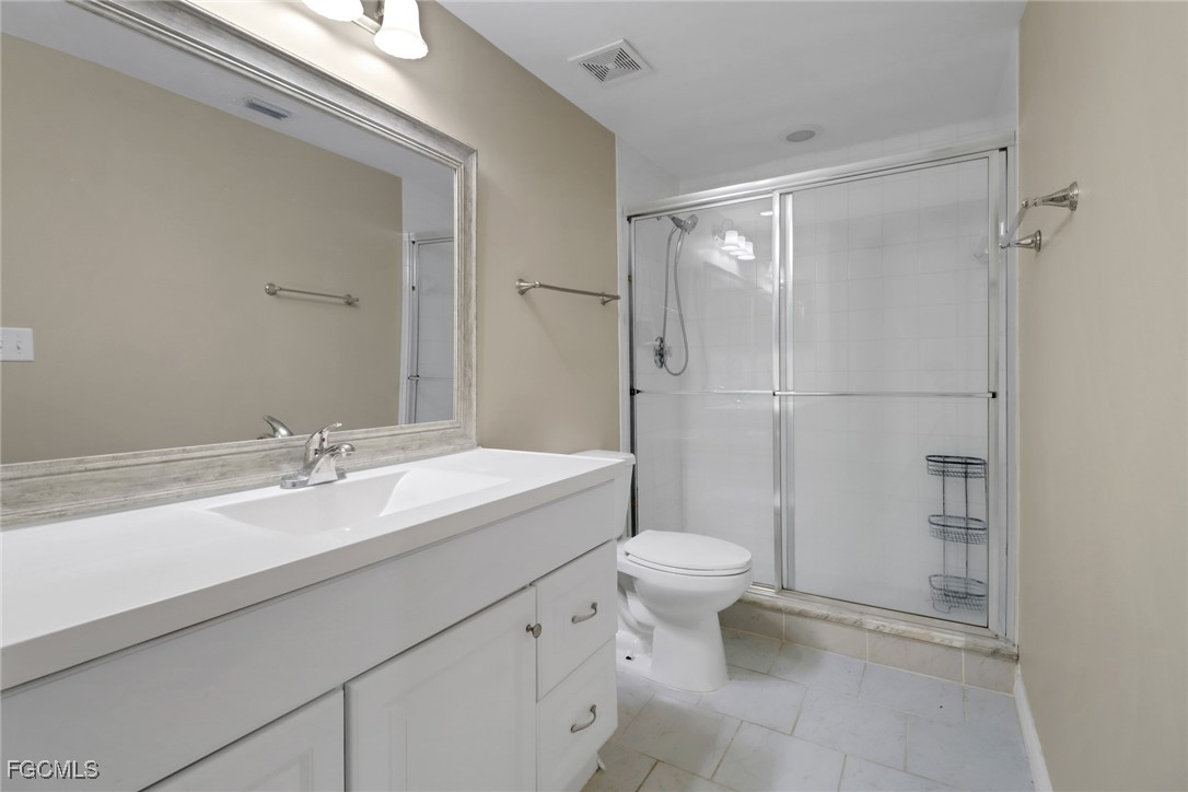 100 Siena Way, Unit 1201 Naples, FL 34119 - Photo 19 of 25 a bathroom with a sink a toilet and shower