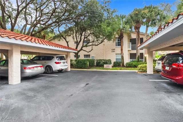 a view of a cars park in front of a building