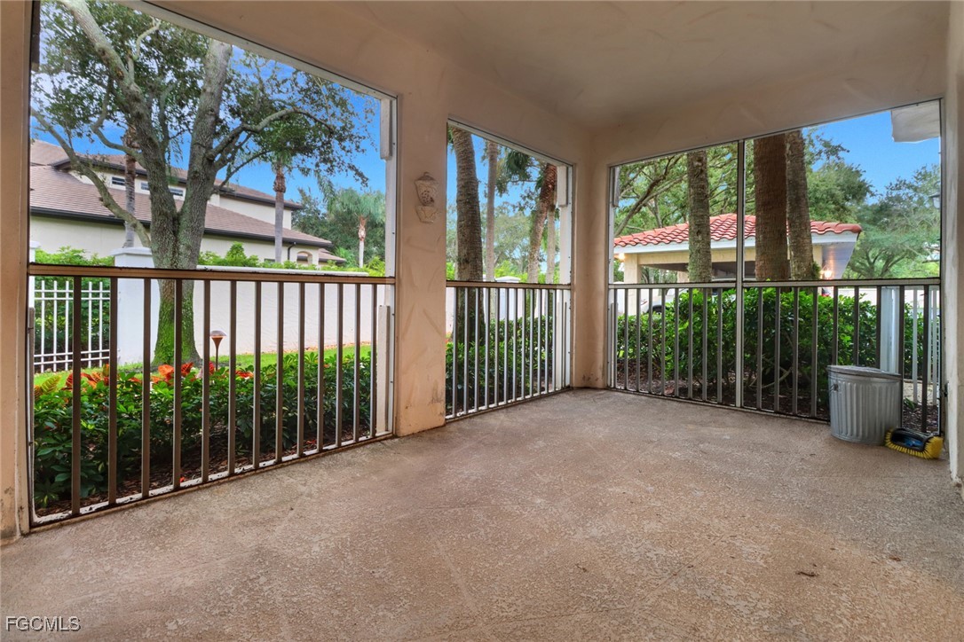 100 Siena Way, Unit 1201 Naples, FL 34119 - Photo 21 of 25 a view of a house with large windows and plants