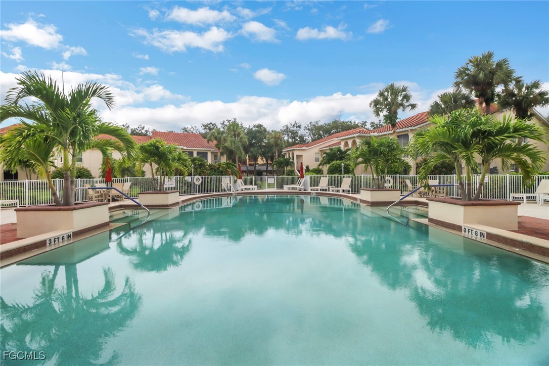 100 Siena Way, Unit 1201 Naples, FL 34119 - Photo 24 of 25 a view of residential house with outdoor space and lake view