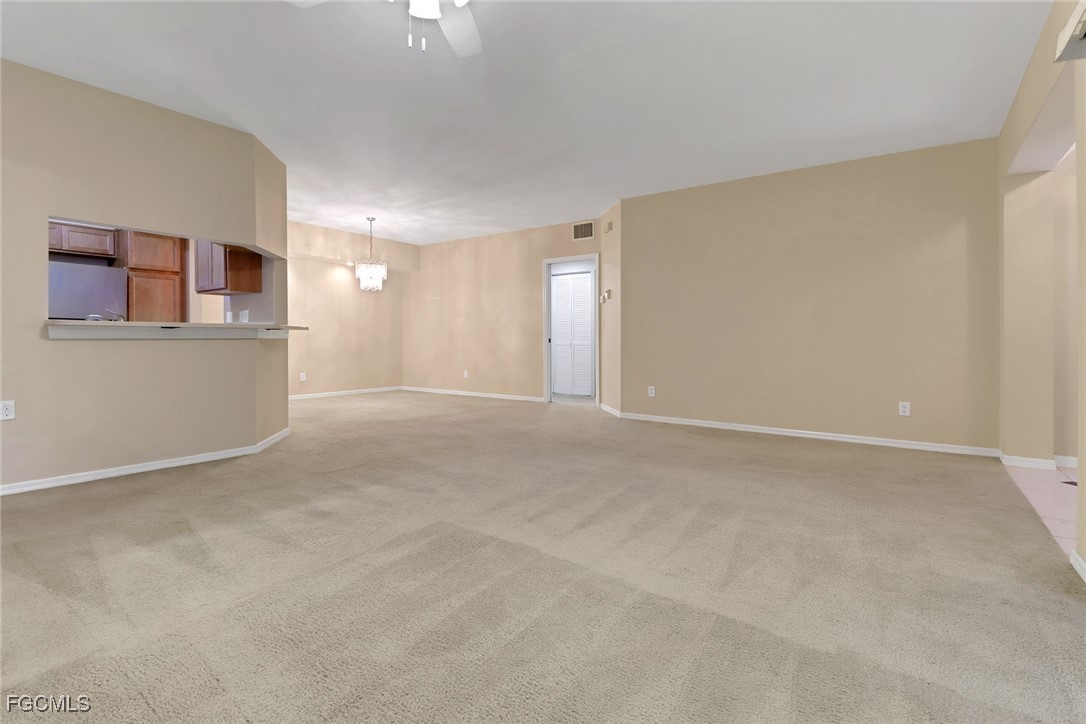 100 Siena Way, Unit 1201 Naples, FL 34119 - Photo 4 of 25 a view of a big room with windows and cabinet