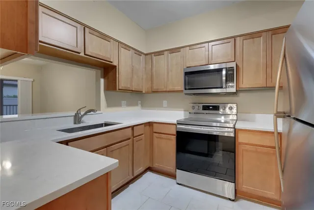 a kitchen with stainless steel appliances granite countertop a sink stove and microwave