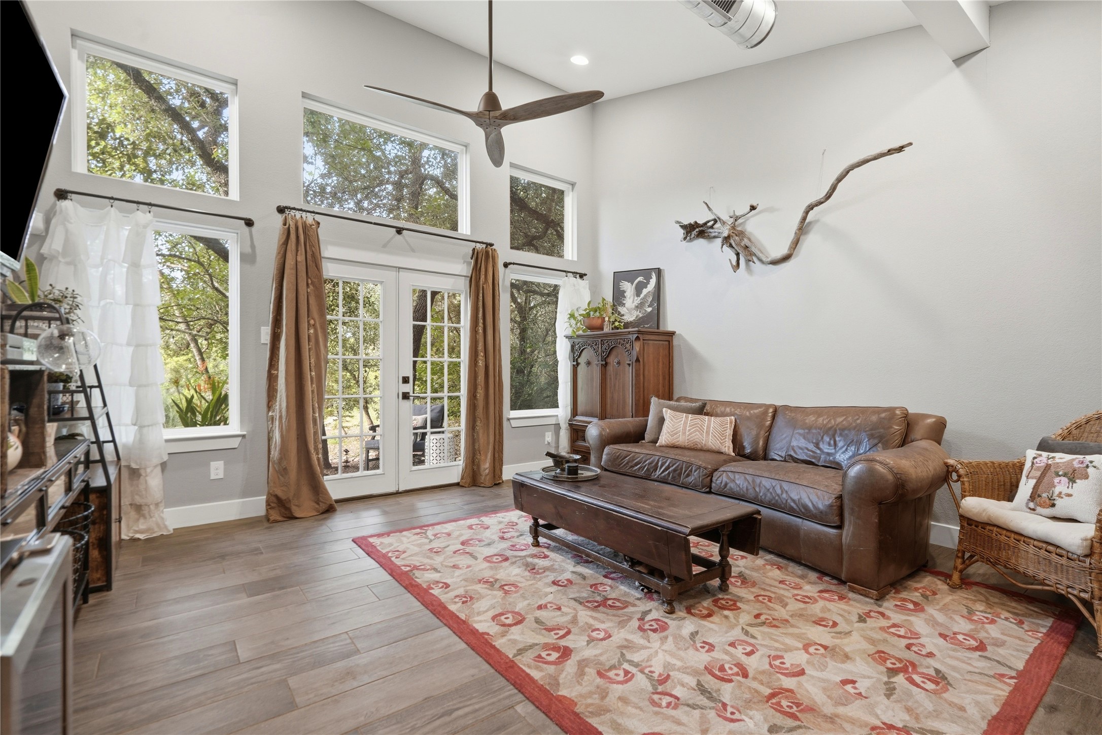 18406 Roundrock Road Jonestown, TX 78645 - Photo 21 of 33 a living room with furniture windows and a flat screen tv