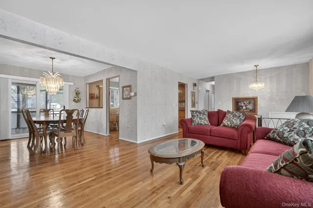 a living room with furniture or wooden floor and a chandelier