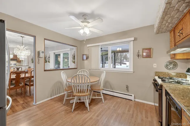a view of a workspace with furniture and wooden floor