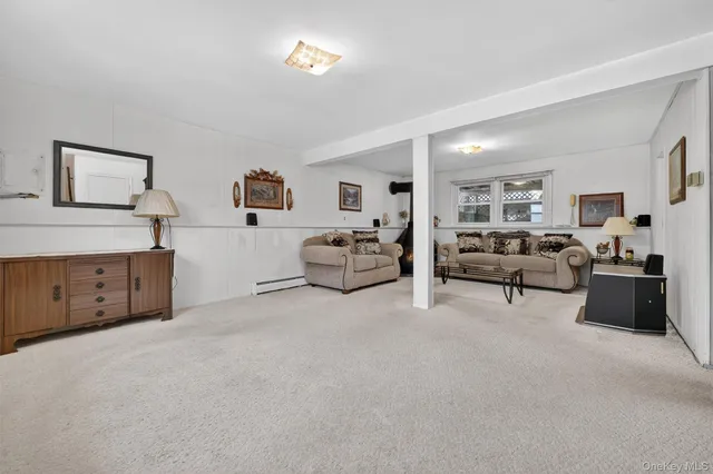 a living room with furniture and a lamp