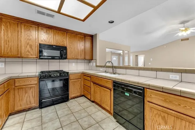 a kitchen with granite countertop cabinets stainless steel appliances and a counter space