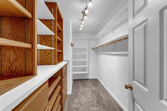 a spacious bathroom with a granite countertop toilet sink and mirror