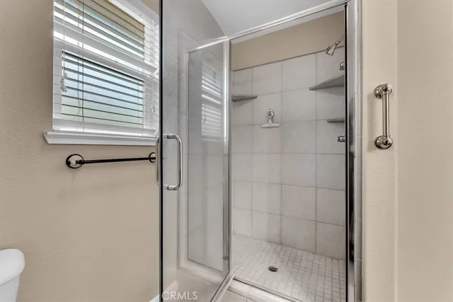 an empty room with window and ceiling fan