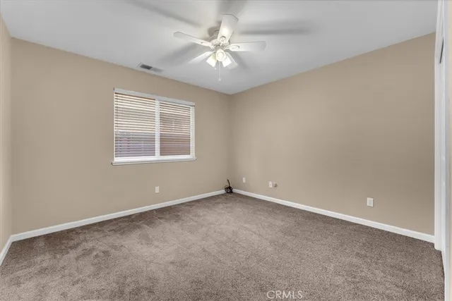 a view of a hallway with white walls and stairs