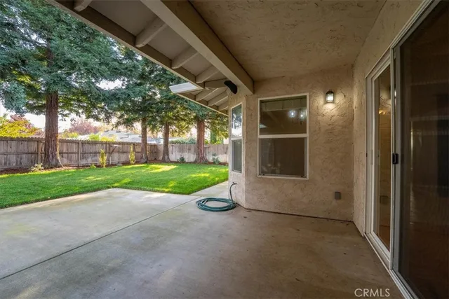 a backyard of a house with fountain table and chairs
