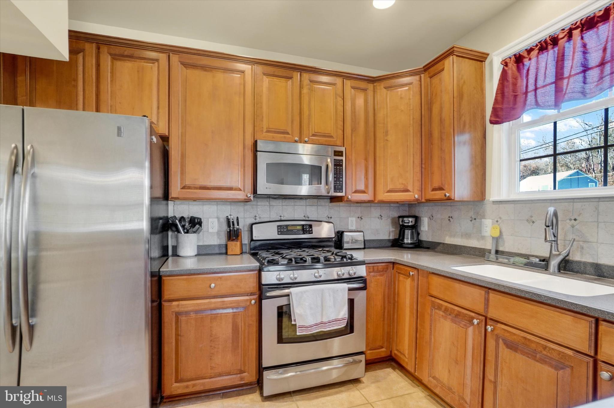 258 North Front Street New Freedom, PA 17349 - Photo 12 of 33 a kitchen with stainless steel appliances granite countertop a refrigerator sink and cabinets