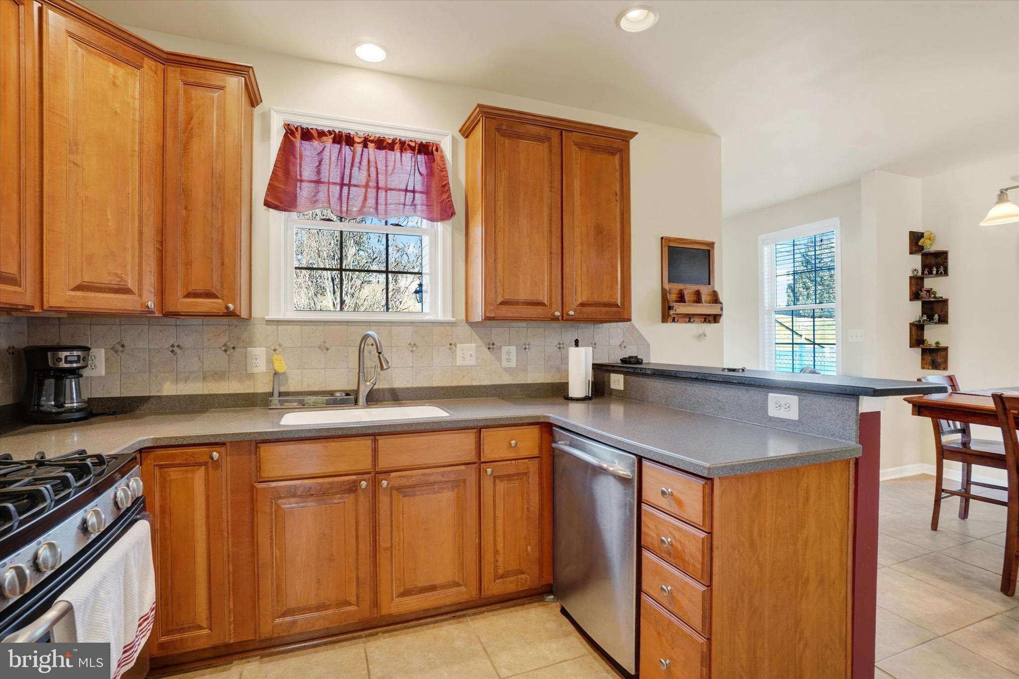 258 North Front Street New Freedom, PA 17349 - Photo 13 of 33 a kitchen with stainless steel appliances granite countertop a sink stove and refrigerator
