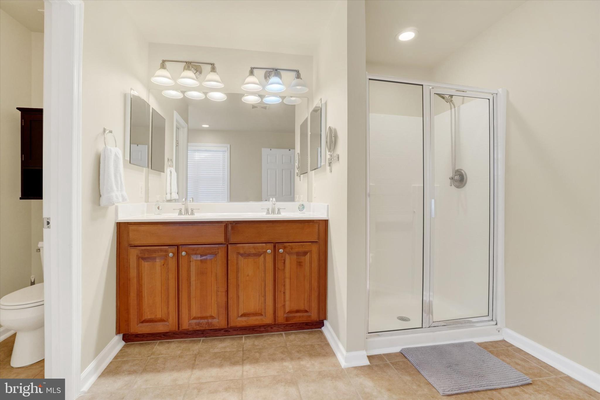 258 North Front Street New Freedom, PA 17349 - Photo 23 of 33 a bathroom with a mirror a sink and a shower