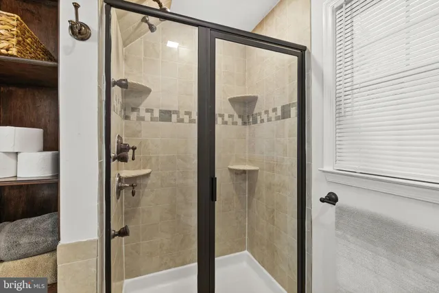 a bathroom with a glass shower door and a sink