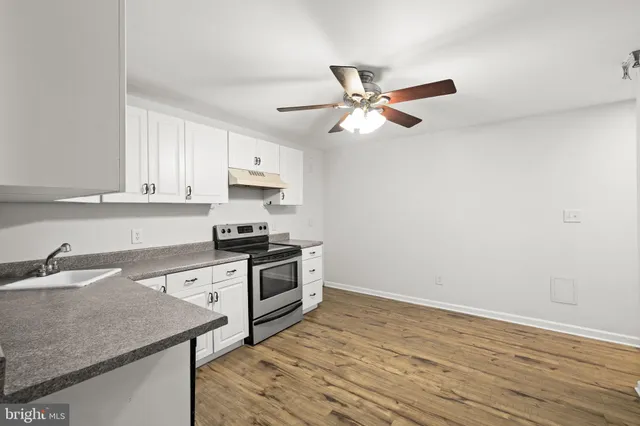 a kitchen with a stove cabinets and a counter top space