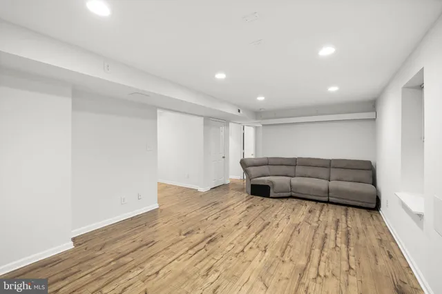 a living room with a couch and a wooden floor