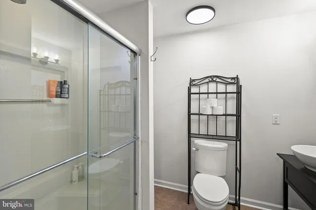 a bathroom with a toilet a sink and shower