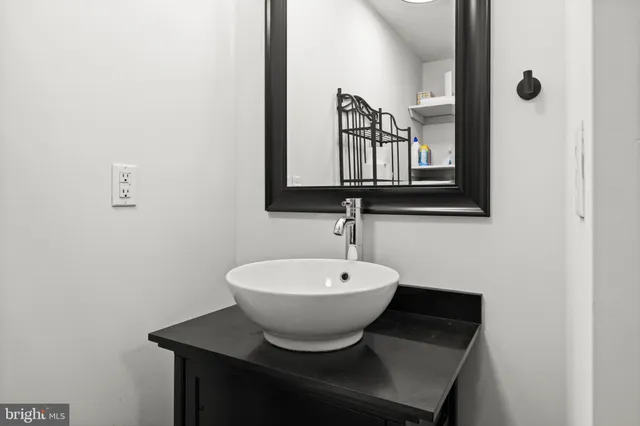 a bathroom with a sink toilet and a mirror