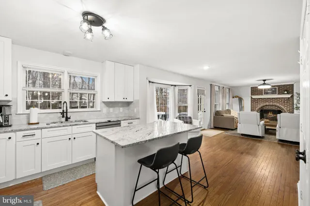 a open kitchen with sink cabinets and wooden floor