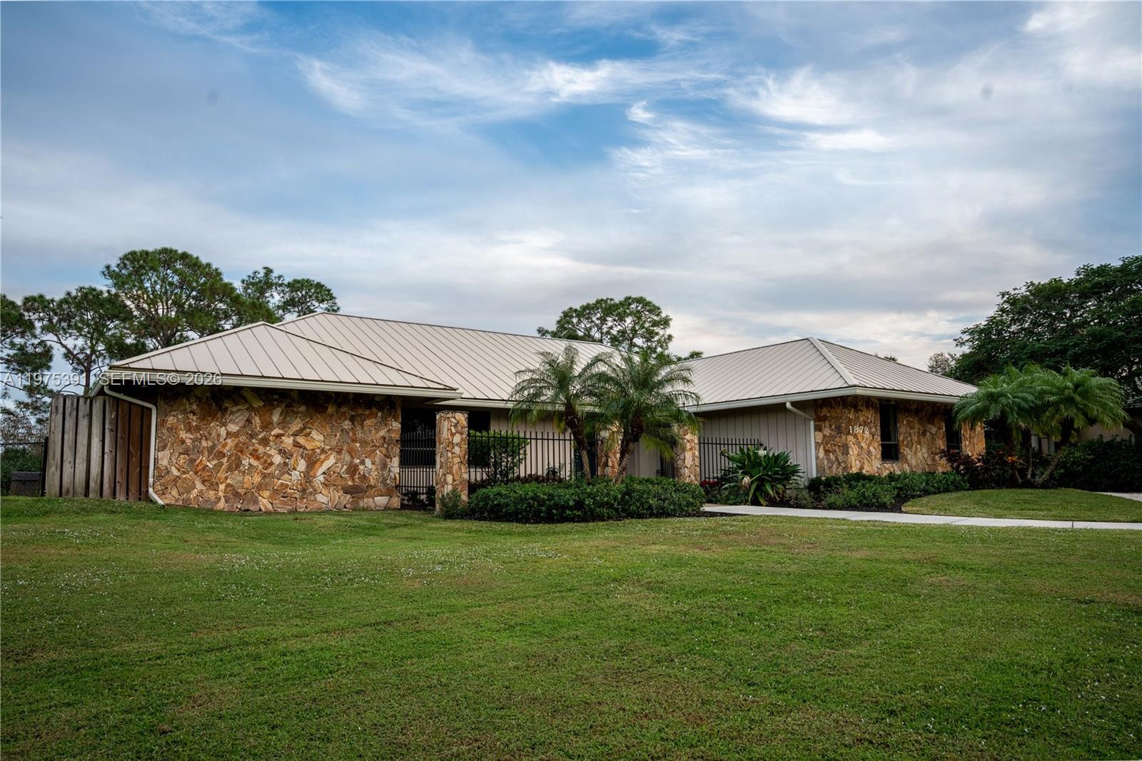 1872 Southeast Colony Way Jupiter, FL 33478 - Photo 4 of 26 a front view of a house with garden